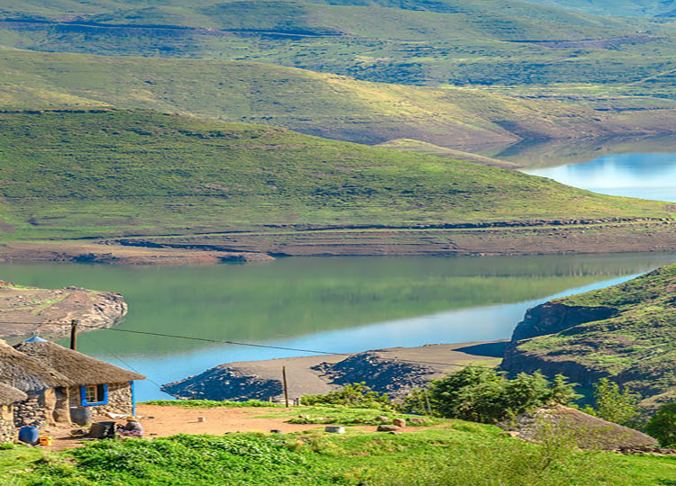 A few stone huts with the beautiful Lesotho countryside in the background.