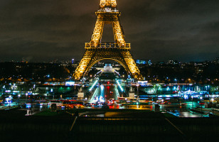 A view of Paris's famous Eiffel Tower lit up at night.