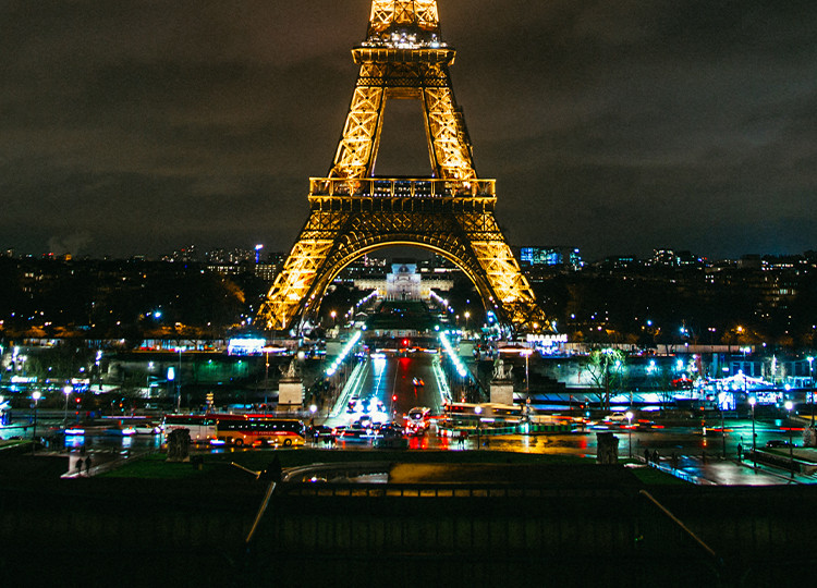 A view of Paris's famous Eiffel Tower lit up at night.