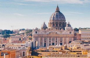 An impressive view of the historic Vatican from a balcony window.