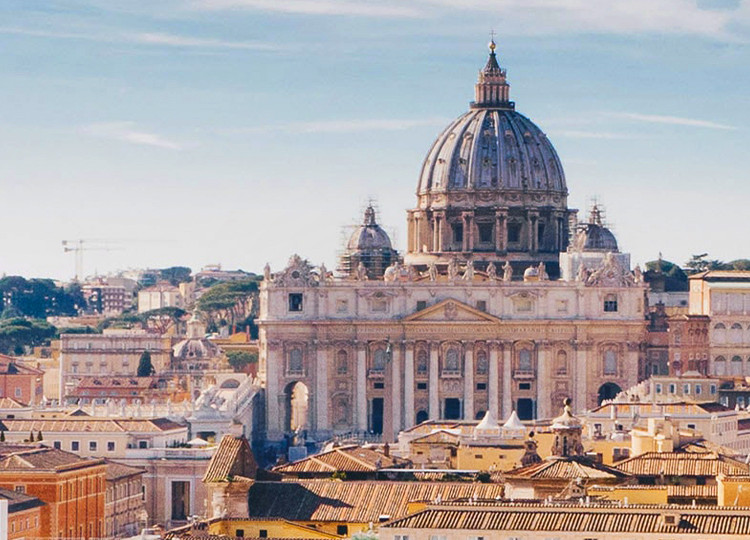 An impressive view of the historic Vatican from a balcony window.