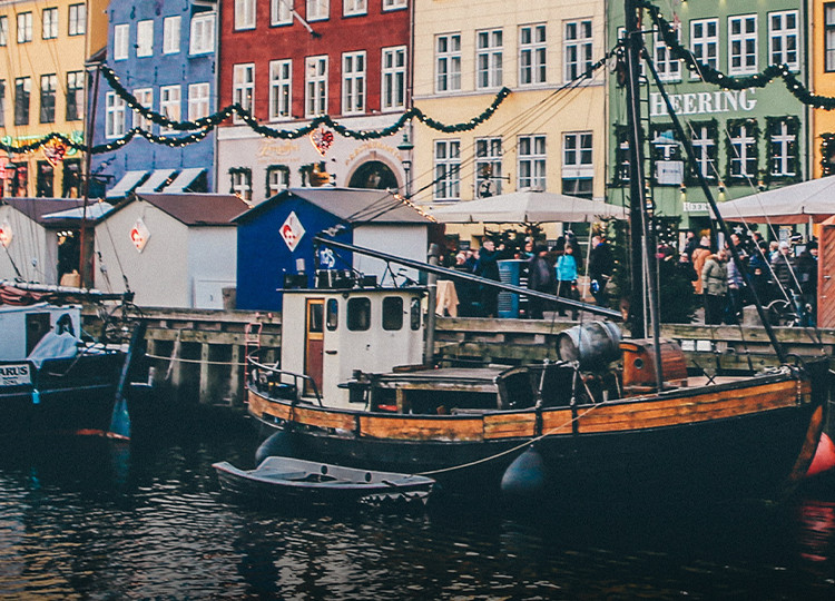 Boats and colorful houses like the docks of Nyhavn harbour in Copenhagen.