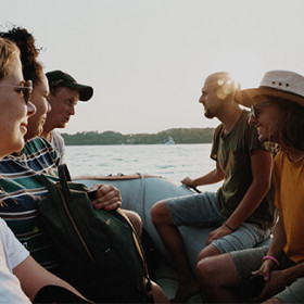 Group of Topdeck travelers on a motorboat.
